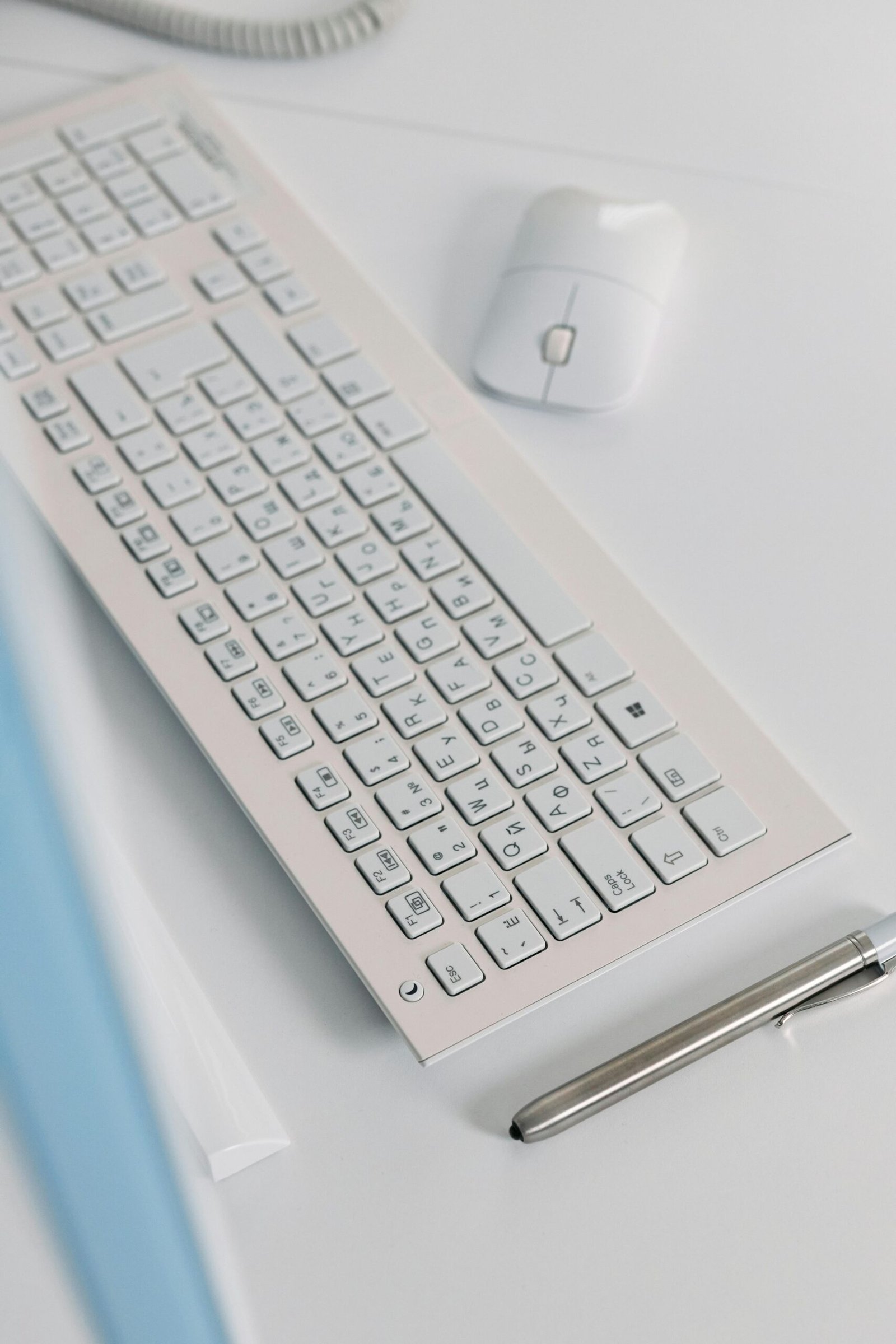 Elegant close-up of a sleek keyboard and mouse on a modern desk setting.